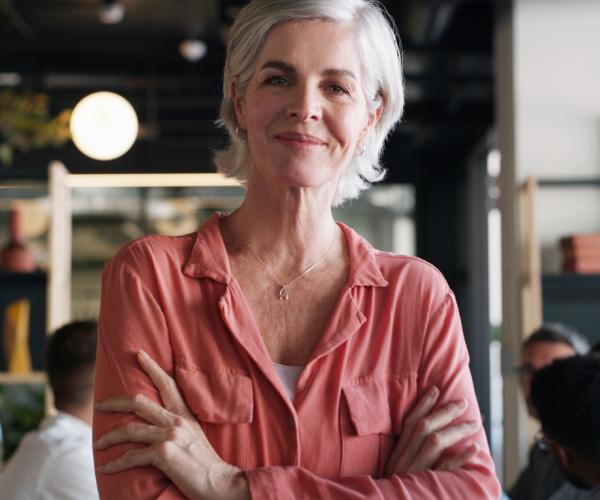 Woman standing in restaurant smiling 