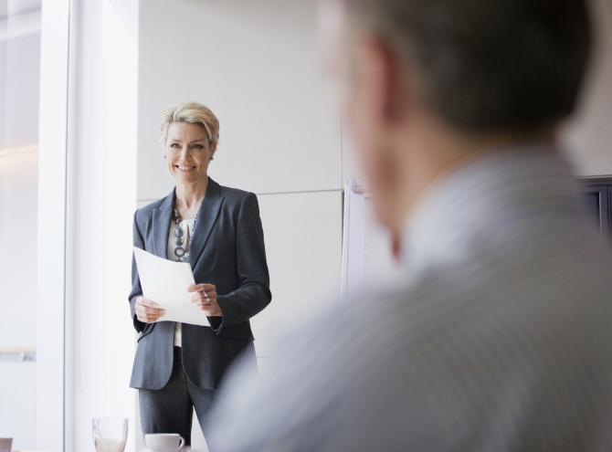 Businesswoman in office holding papers