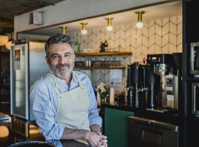 Chef in restaurant smiling.