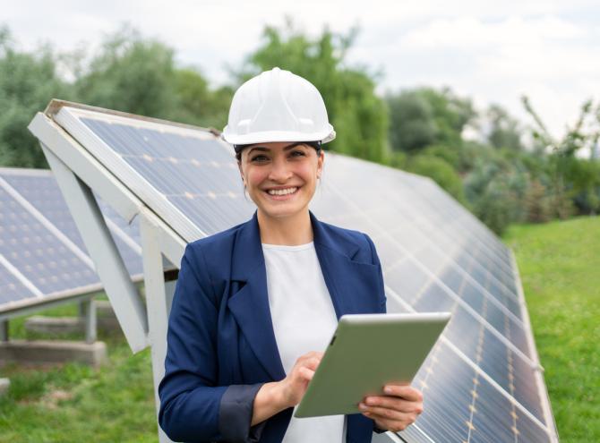 Engineer in safety helmet with tablet