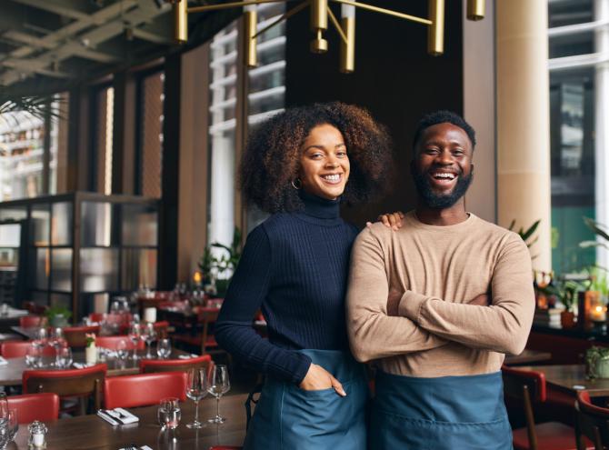 Couple in restaurant smiling 