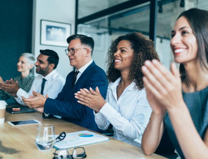 Group of people clapping after business presentation 